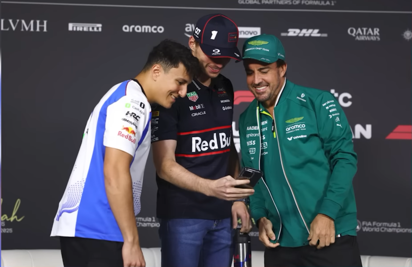 Issack, Max, and Fernando take a photo with Alex Albon's phone